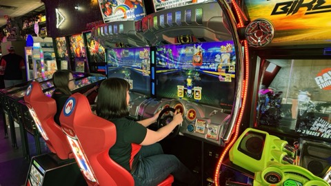 Guests racing the arcade cabinets at The Flipside
